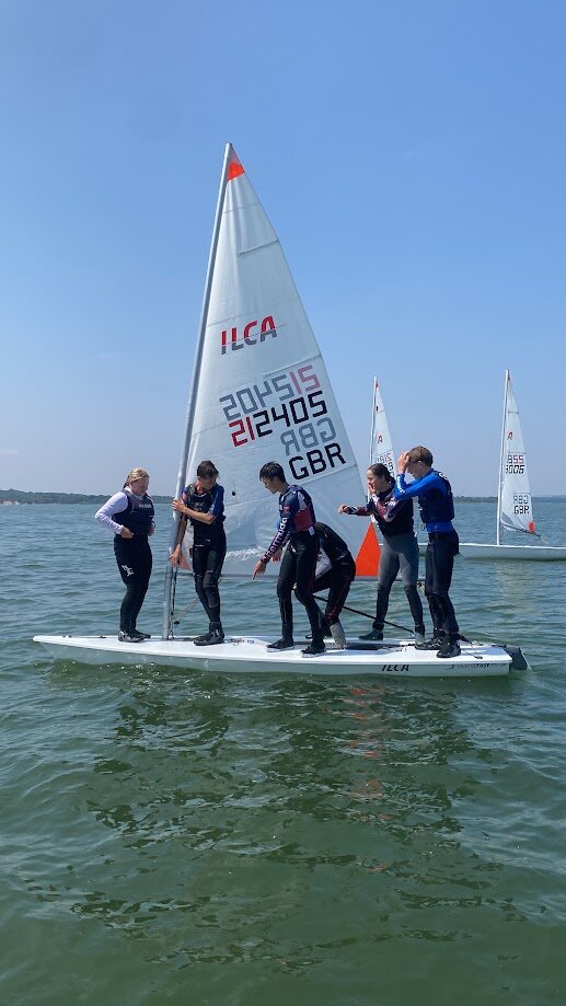 ILCA sailors taking part in an on-water coaching exercise